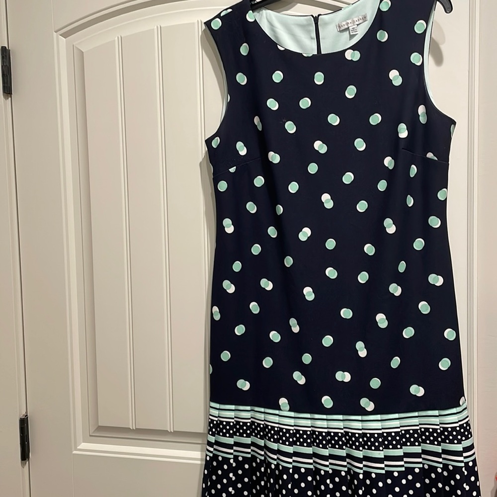 Navy knee length dress with light green and white polkadots;